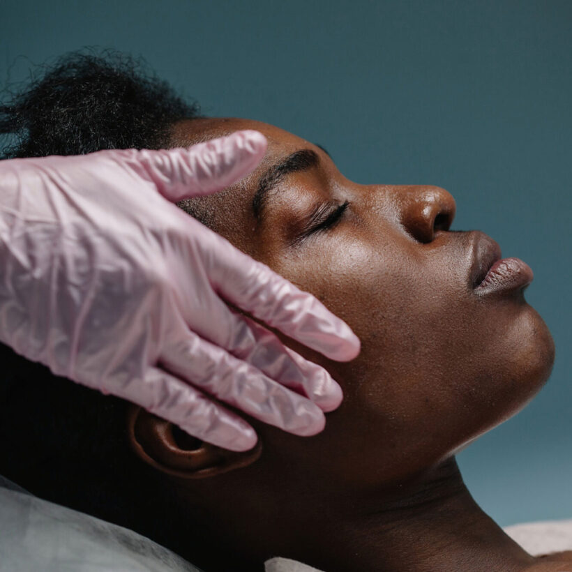 woman getting a facial procedure at spa