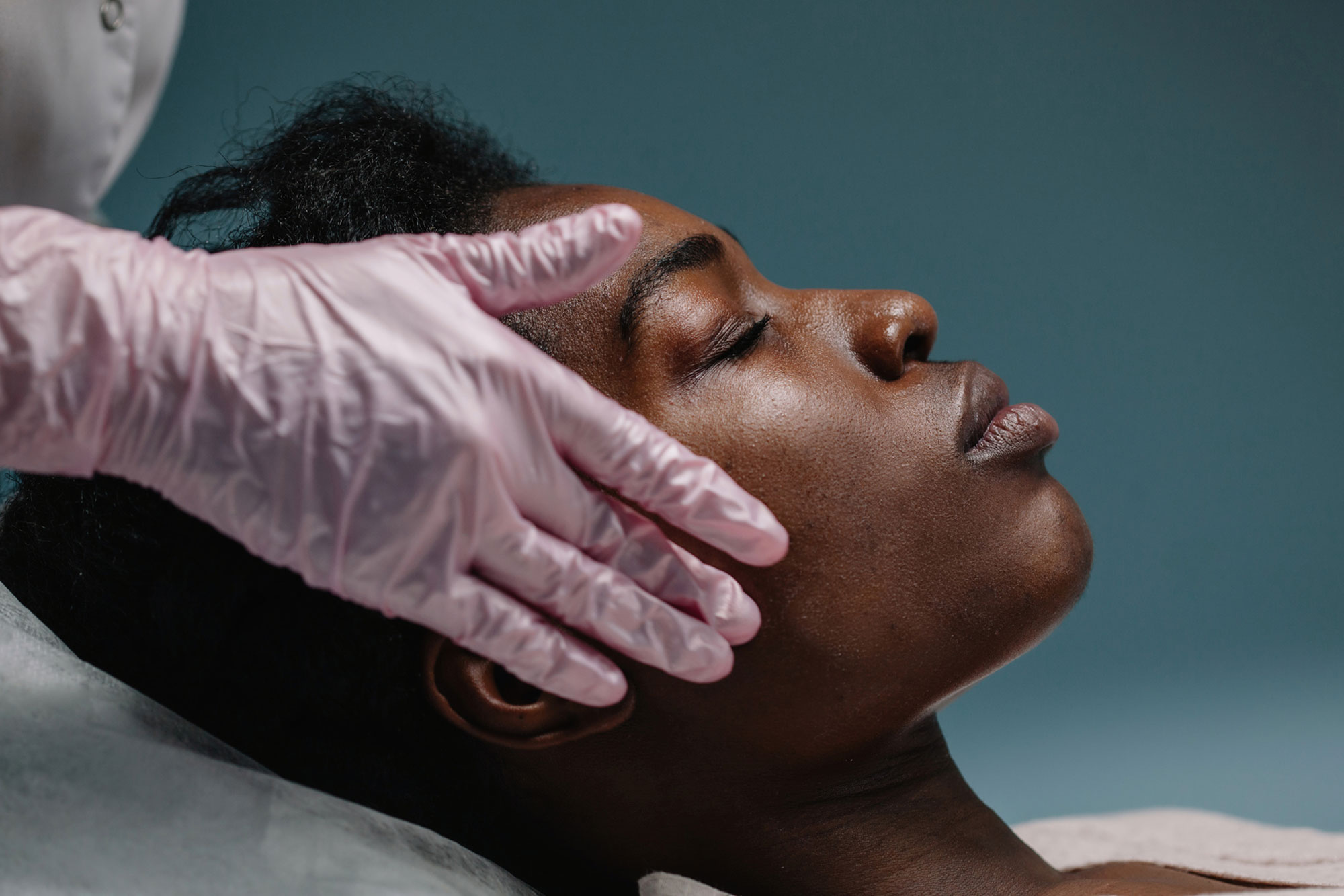 woman getting a facial procedure at spa