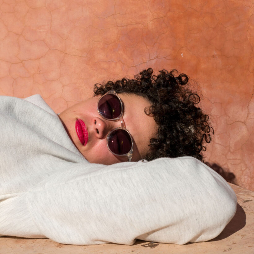 woman with sunglasses laying in sun