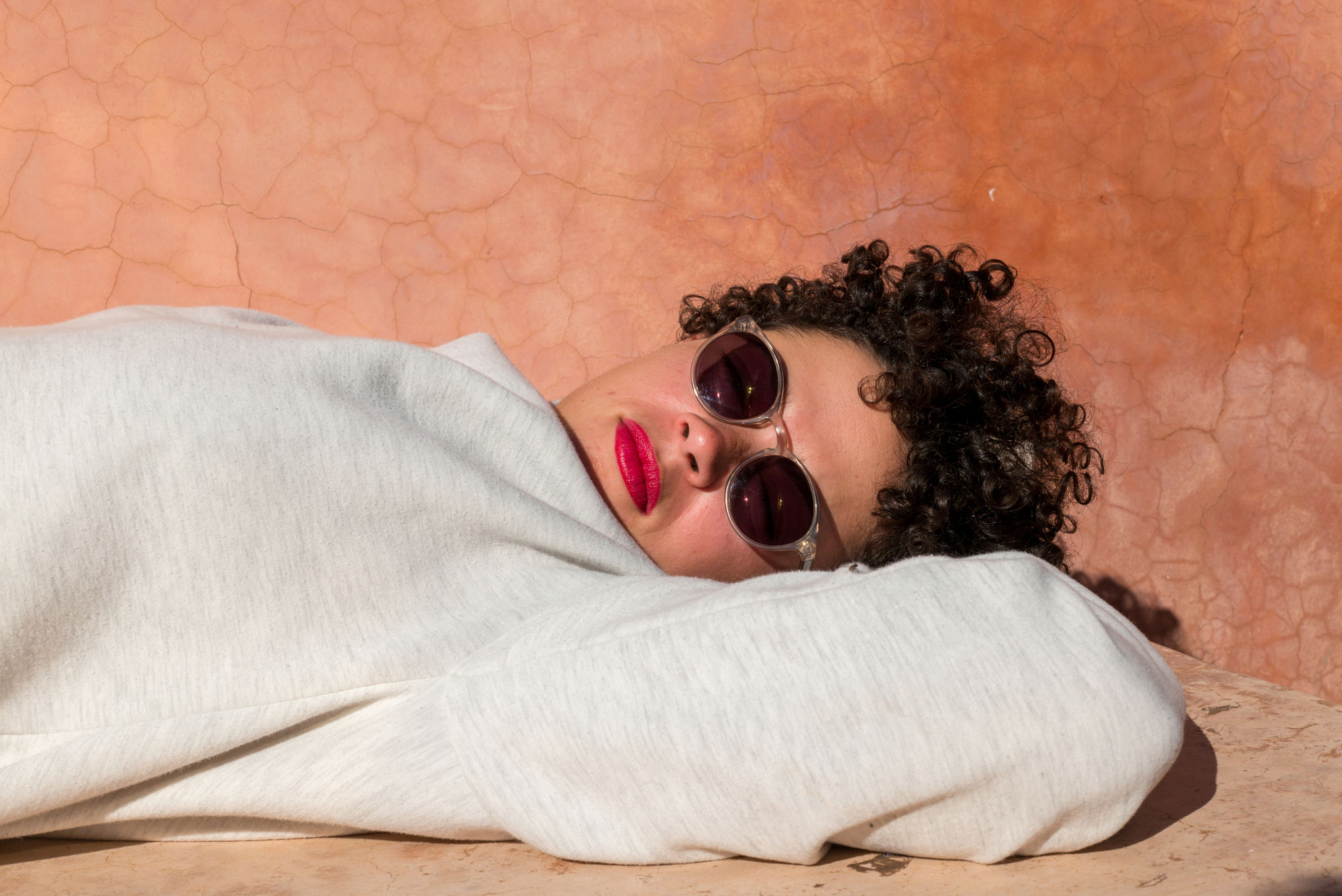 woman with sunglasses laying in sun