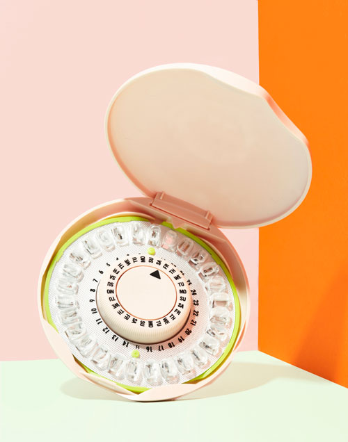 Birth Control Pill Dispenser on pink and orange background