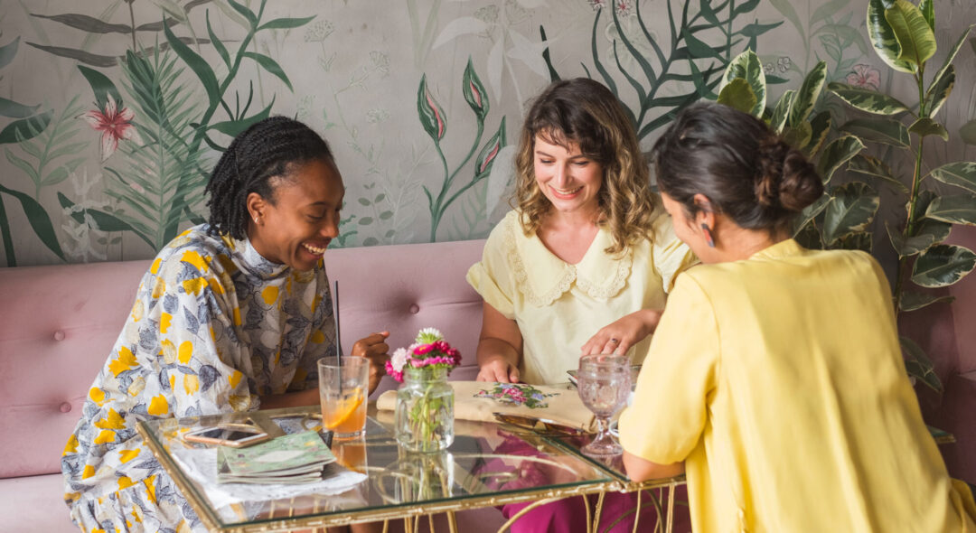 group of women at table looking at crafts