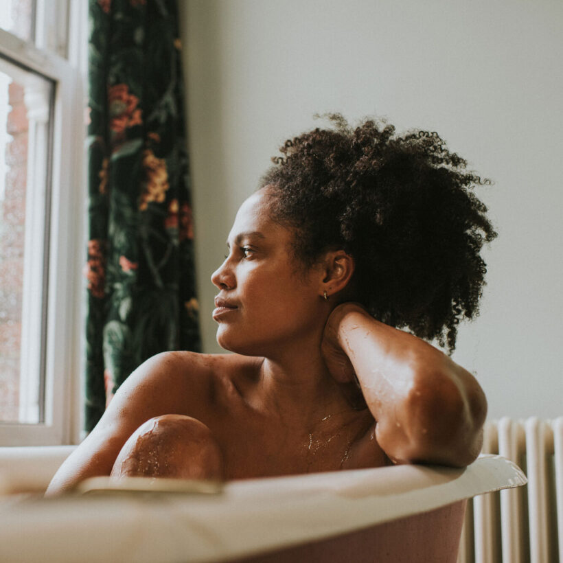 woman in tub looking out the window