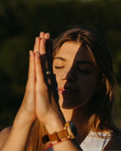 Portrait Young Woman Practicing Yoga and Meditation with Folded Hands Outdoors at Sunset