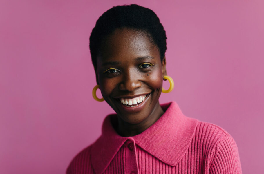 portrait of woman in pink studio background with bright makeup