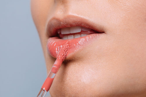 woman applying lip color