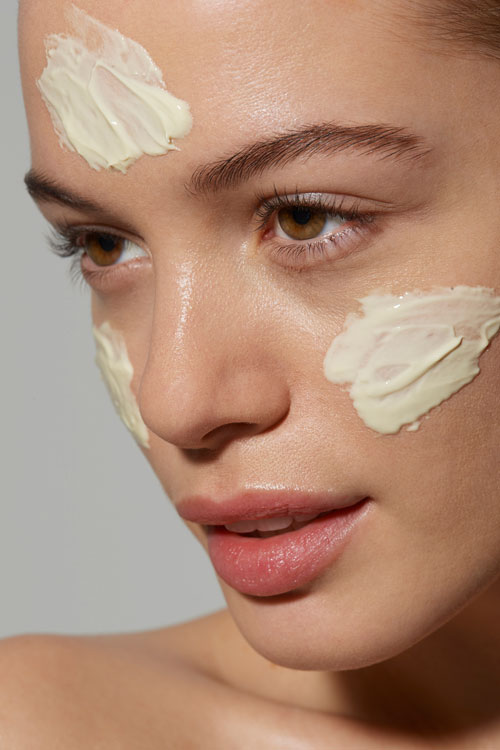 close up of woman's face with face cream
