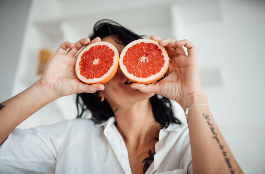 Woman Holding Grapefruit Slice At Home