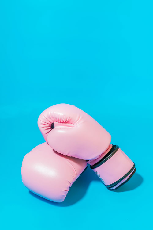 Pink Boxing Gloves Against Blue Background