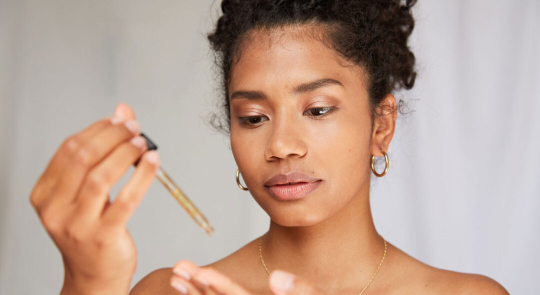 woman applying serum to hand