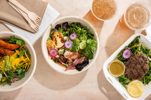 overhead shot of salads and drinks