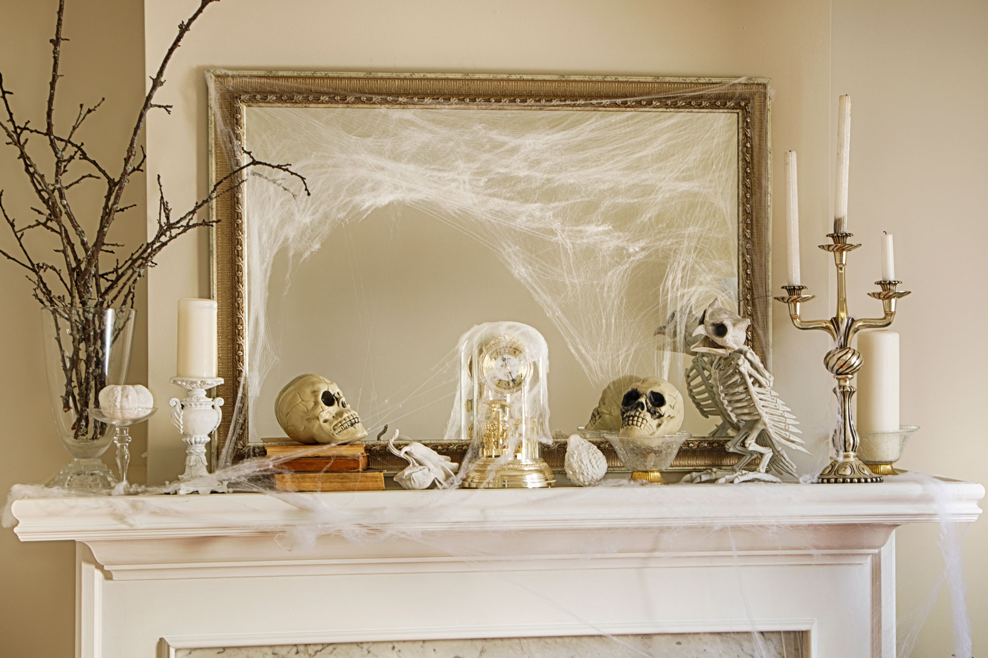 Fireplace mantel covered in Halloween decorations.