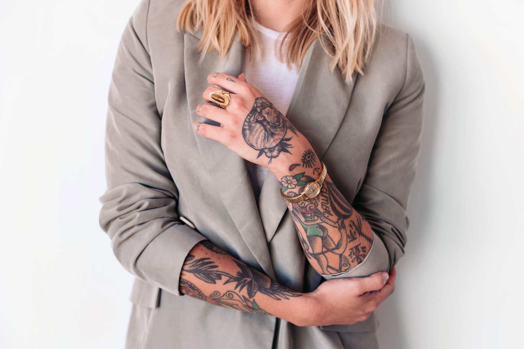 woman's arms covered in tattoos