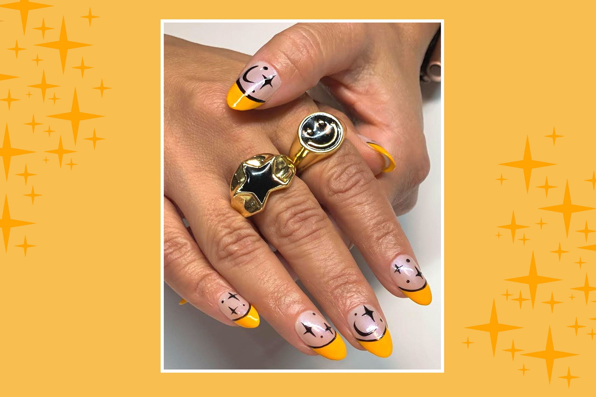 woman's nails with moon and star pattern painted on