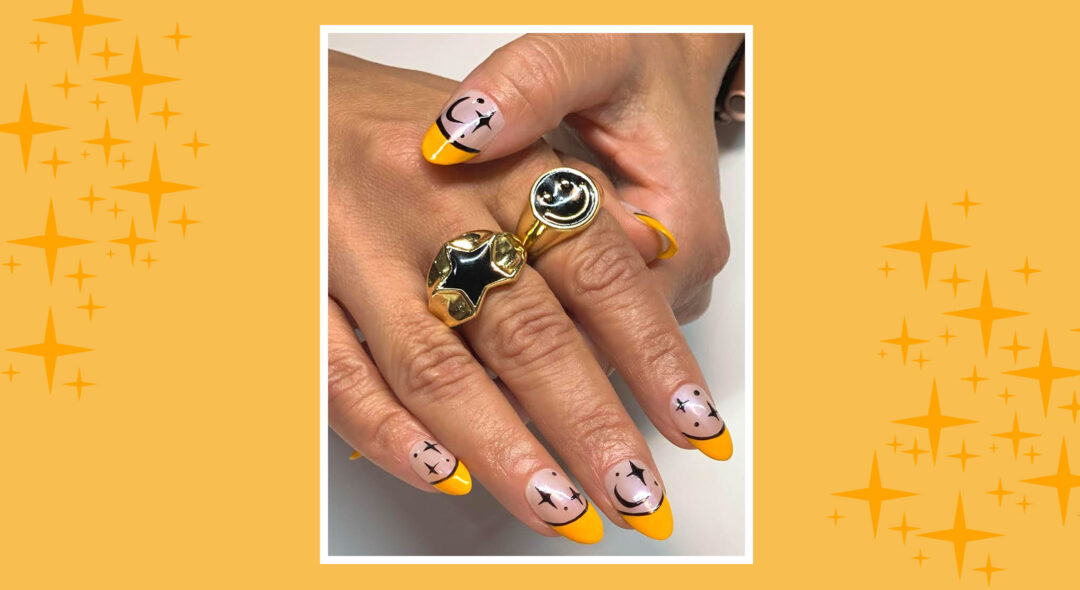 Woman's hands with moon and star pattern on nails