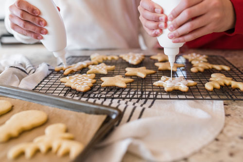 Two people baking christmas cookies