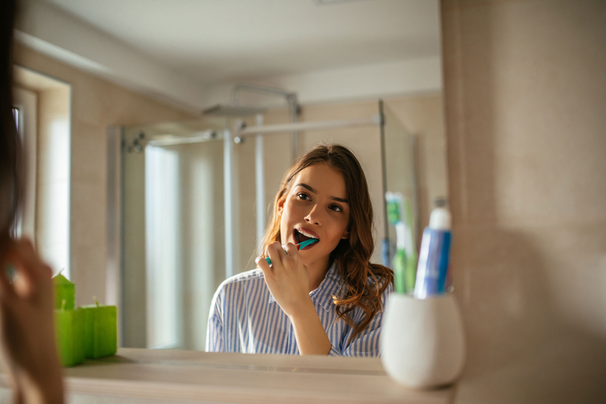 woman brushing teeth in the bathroom