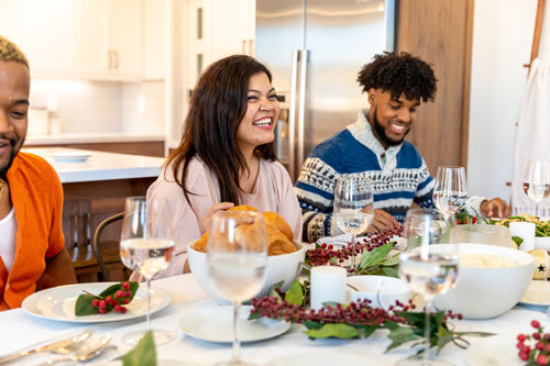 Woman Smiles During Holiday Dinner