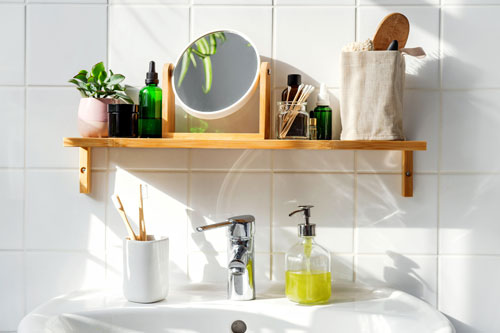 shot of bathroom sink with shelf full of products