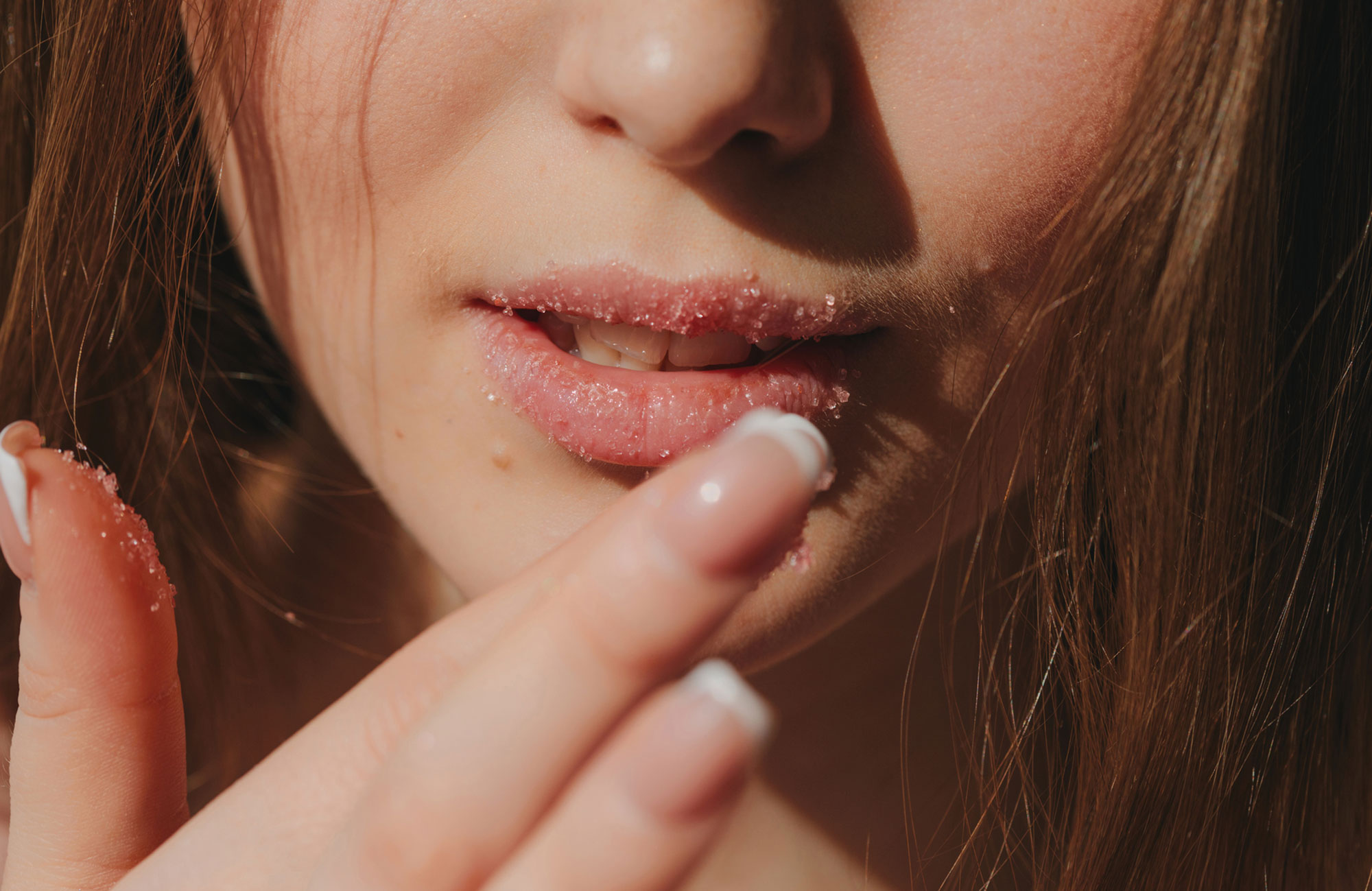 woman applying lips scrub