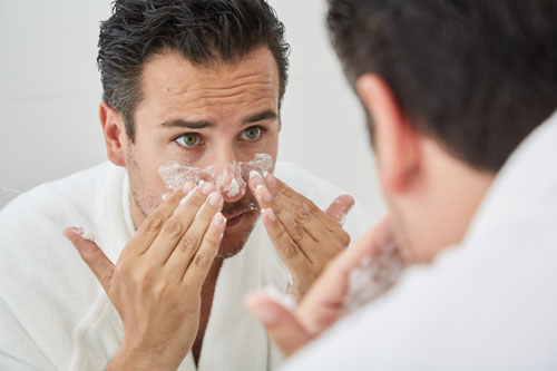 Man exfoliating nose