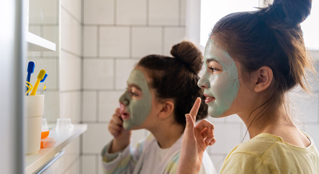Girls applying beauty product in the bathroom