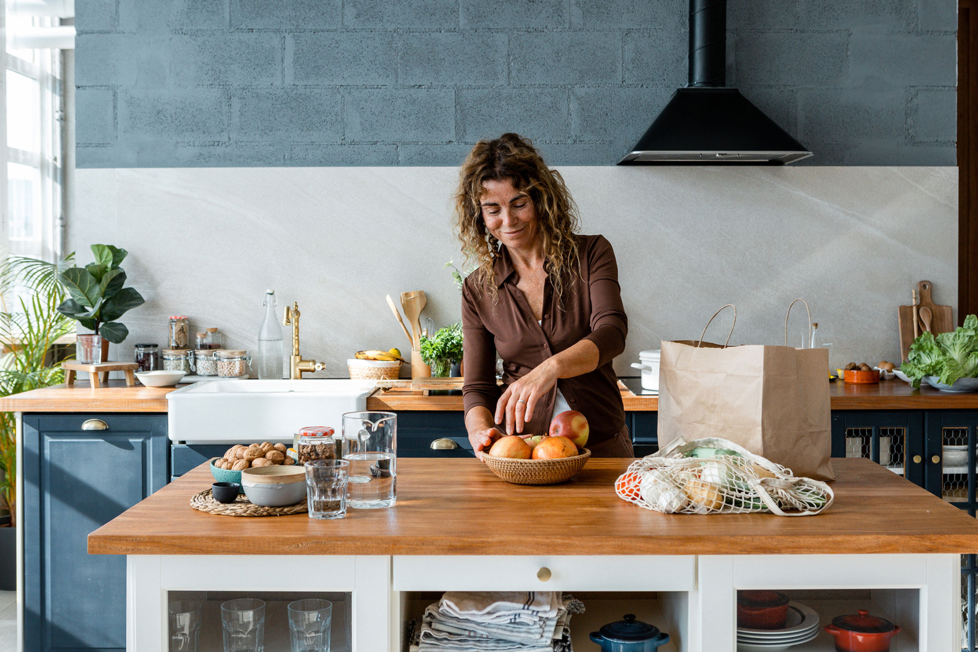 Woman unpacking the groceries in the kitchen