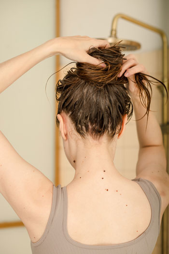 woman putting wet hair up