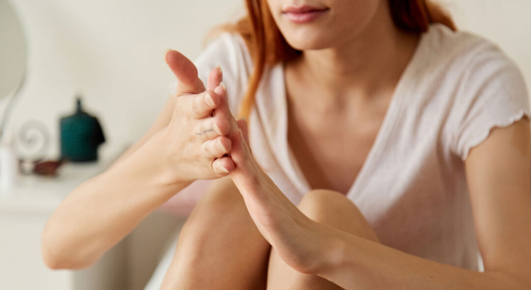 woman applying hand lotion