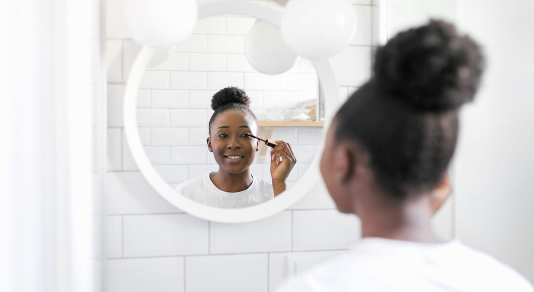 Woman Doing Make Up In Bathroom