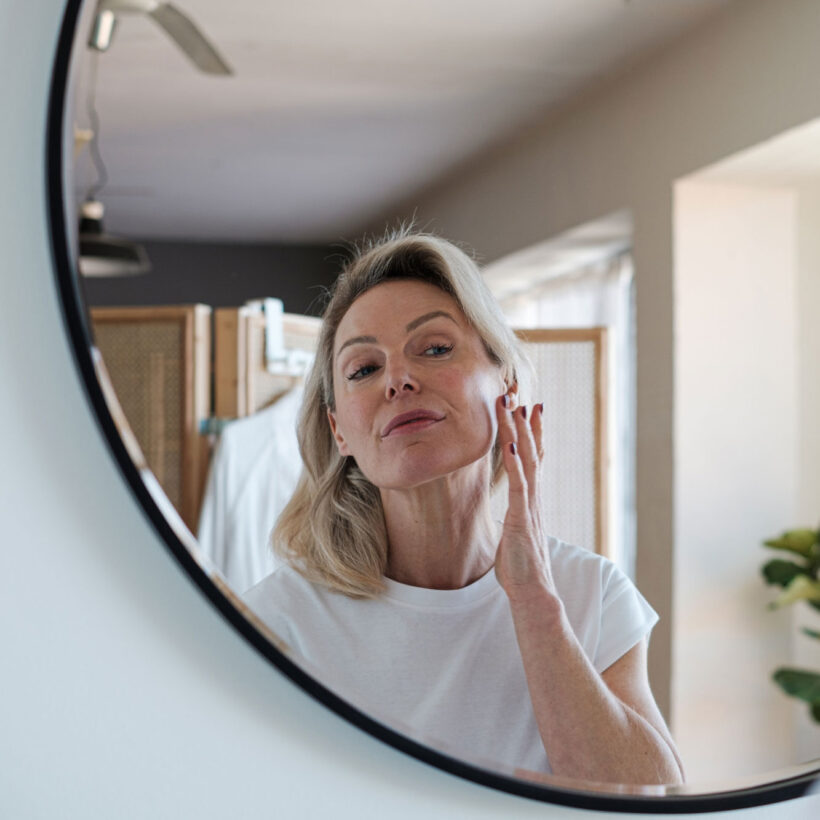 woman applying skincare at home